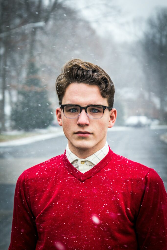 Man-standing-in-snow-wearing-a-red-sweater—Why-do-guys-go-cold-after-breakup